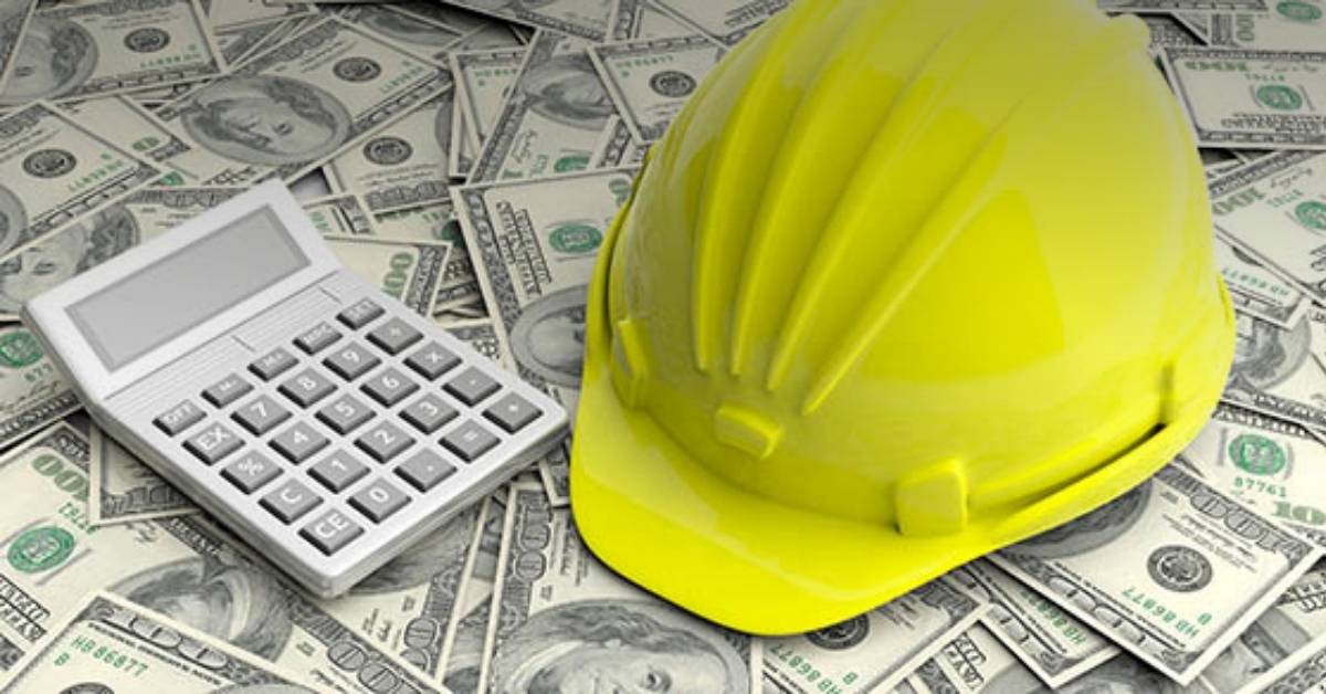 Image of a construction hat on top of a bunch of money, next to a calculator