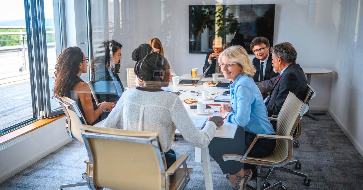 Image of a boardroom with people talking