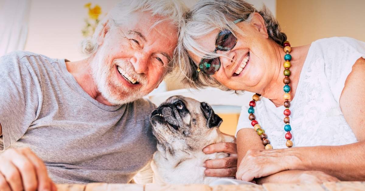 Image of a retired couple with a shelter dog