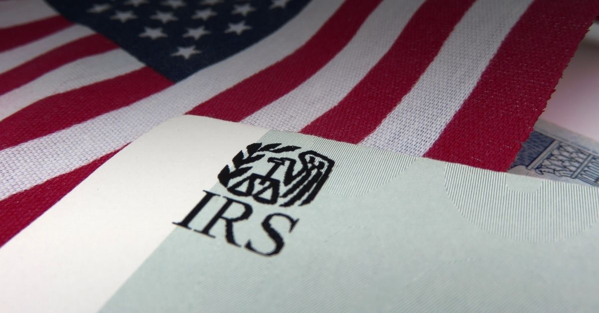 Image of a printed IRS logo and an american flag behind it