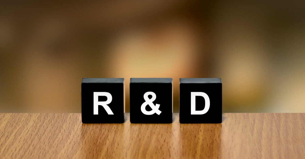 Image of a table with blocks that spell: R & D