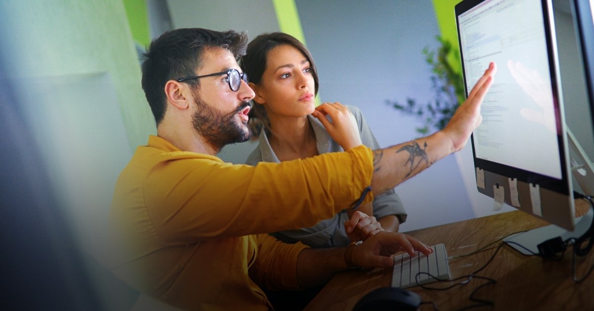 Image of two people at a computer doing research and development