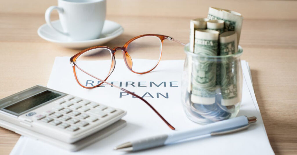 Image of a desk with a paper that says 'Retirement Plan'