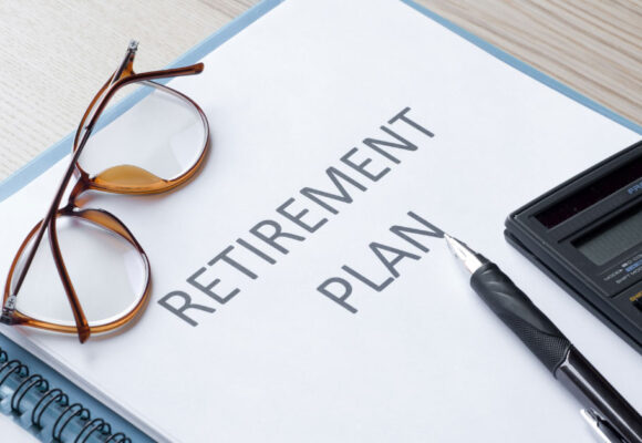 Image of a retirement plan with glasses and a calculator