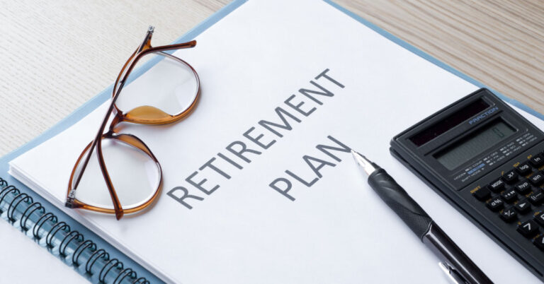 Image of a retirement plan with glasses and a calculator