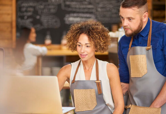 Image of small business owners looking at a computer