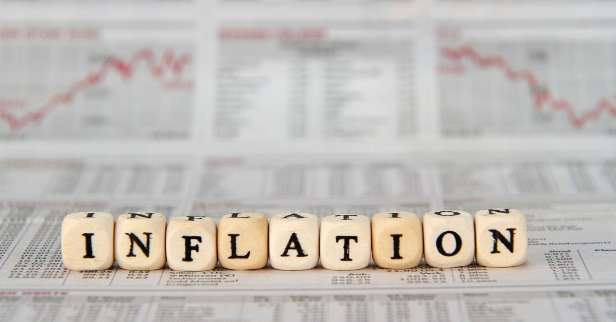 Image of financial charts with blocks that spell out 'Inflation'