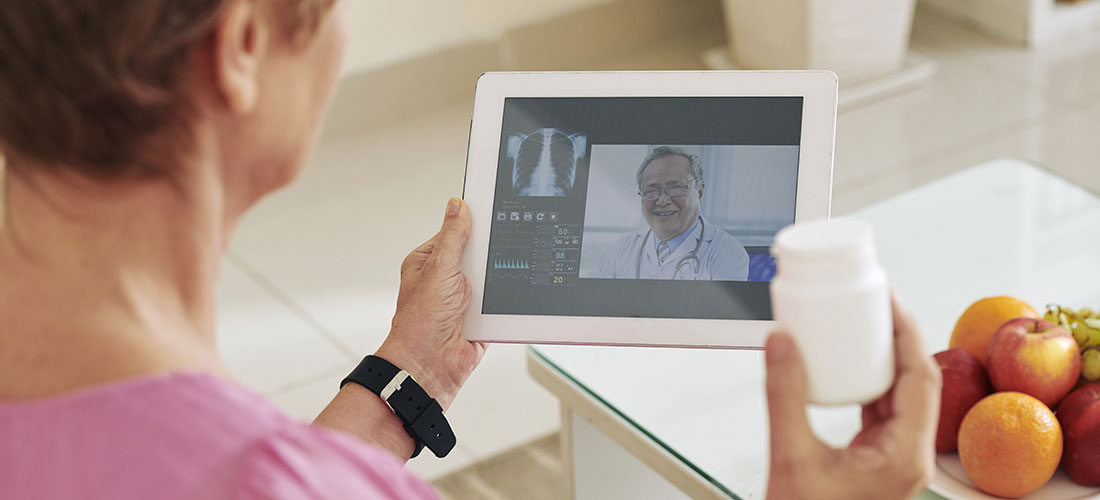 Photo of doctor and patient talking on a telemedicine video appointment