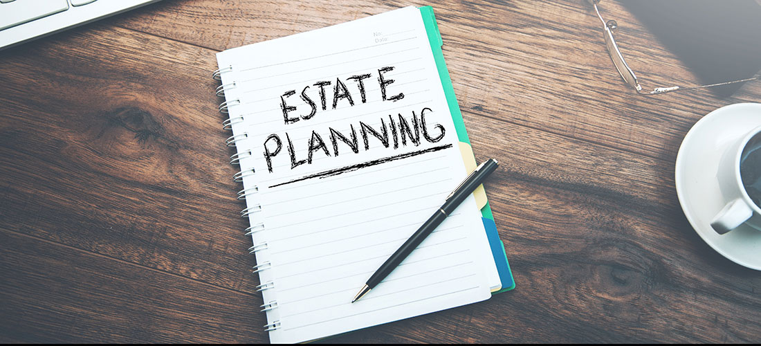 Image of a notebook with the words "estate planning" written on it
