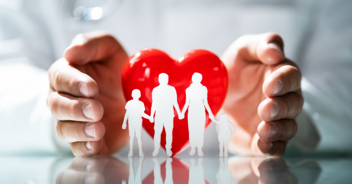 Image of a heart paperweight with small people-figures in front of it