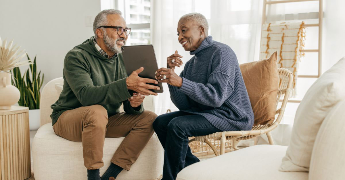 Image of a retired couple looking at an iPad